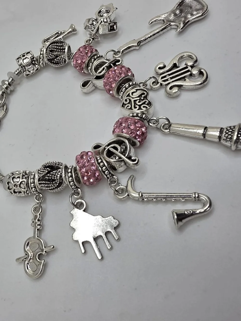 Silver Music Charm Bracelet with Pink Accents